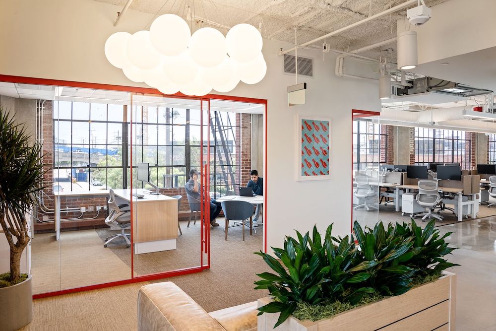 Centrally-visible private office welcomes connection and conversation. Credit: RAM Construction 
