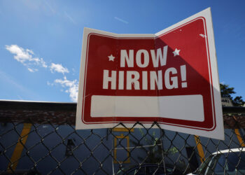 A "now hiring" sign is displayed in Somerville