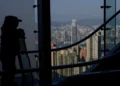Tourists view Hong Kong's skyline from The Peak, with Two International Finance Centre (IFC II) in Central in the background, in Hong Kong, China, February 24, 2025. REUTERS/Tyrone Siu/File Photo