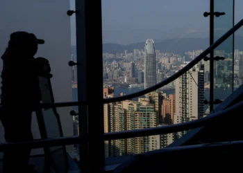 Tourists view Hong Kong's skyline from The Peak, with Two International Finance Centre (IFC II) in Central in the background, in Hong Kong, China, February 24, 2025. REUTERS/Tyrone Siu/File Photo
